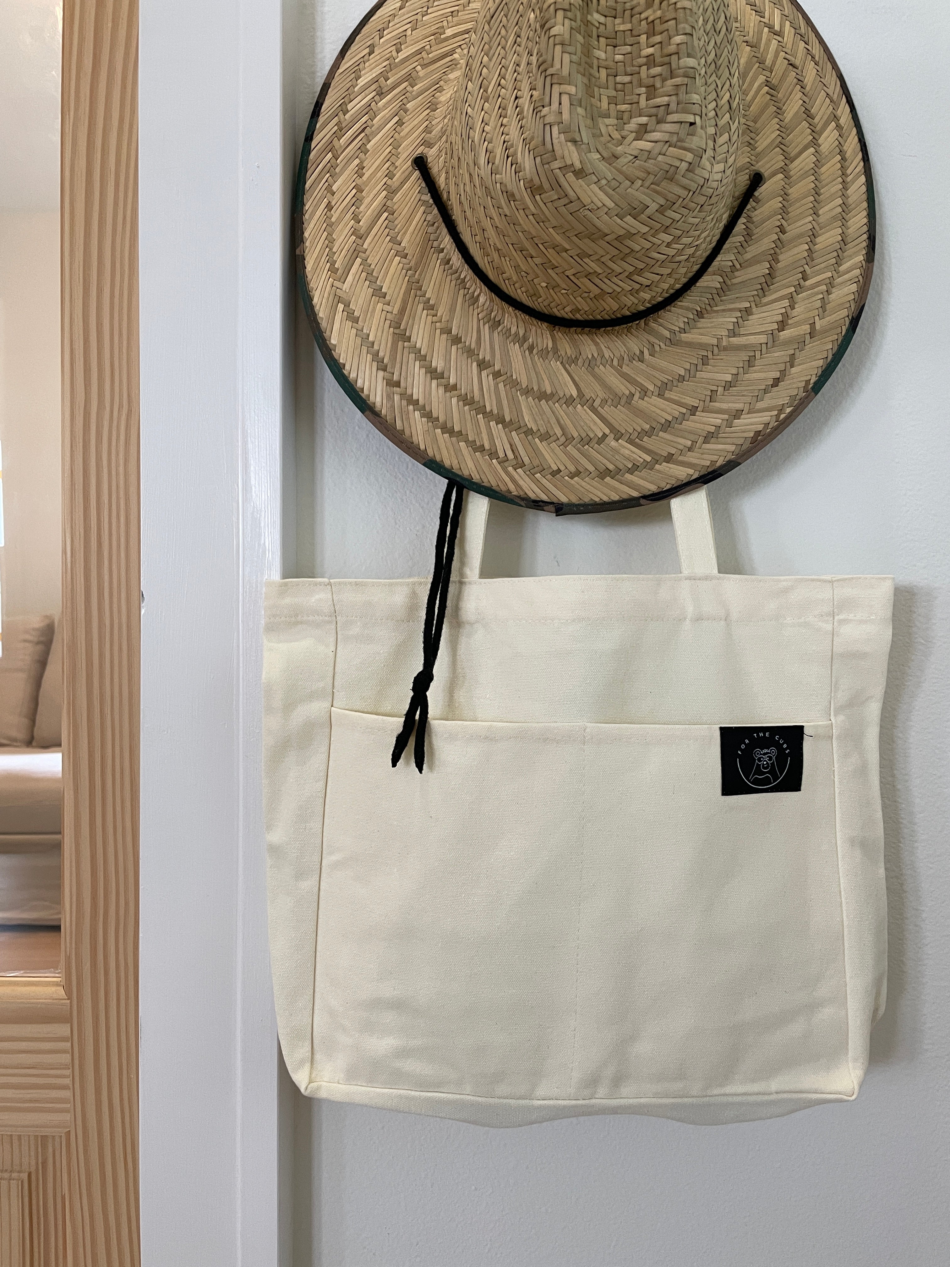 Everywhere tote bag on hook with sun hat