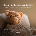 Teddy bear wearing glasses on a couch with a quote about comfort and companionship.