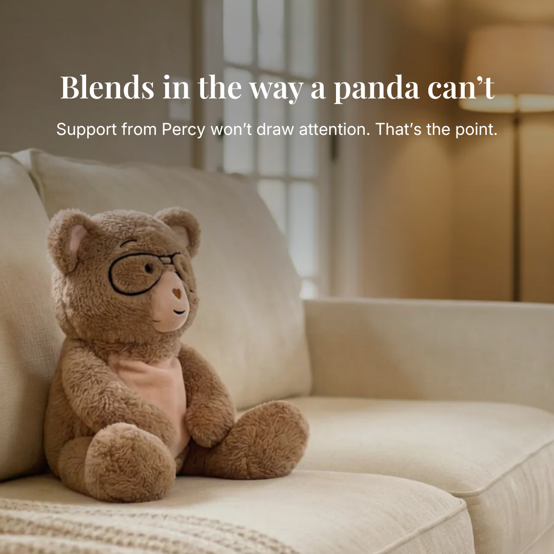 Teddy bear with glasses sitting on a couch with text overlay "Blends in the way a panda cant"