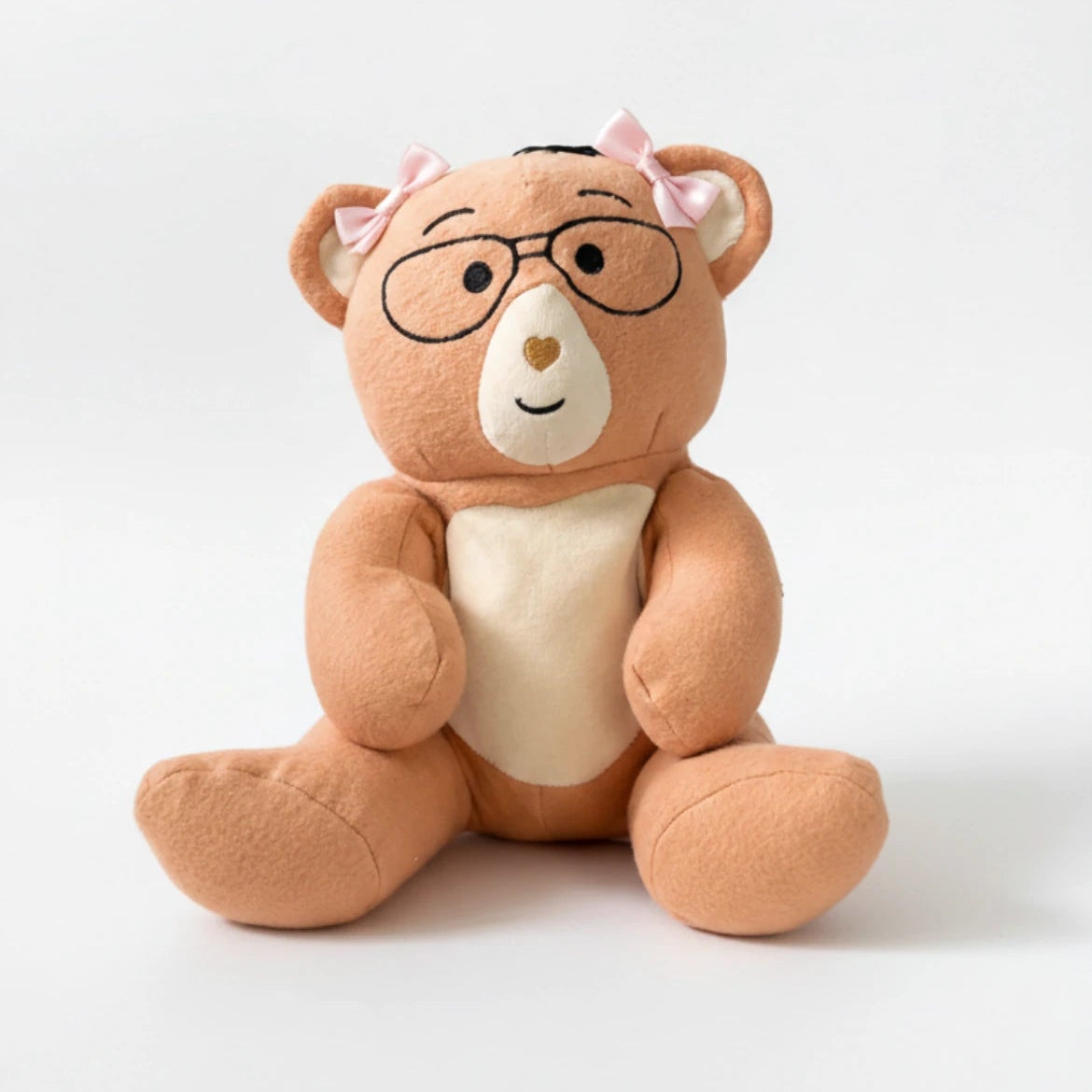 Plush Penny bear with glasses and pink bows on a white background
