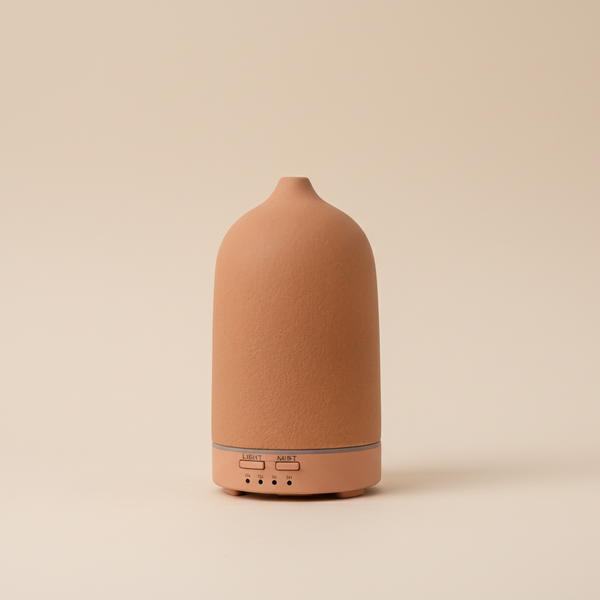 Terracotta-colored diffuser on a beige background