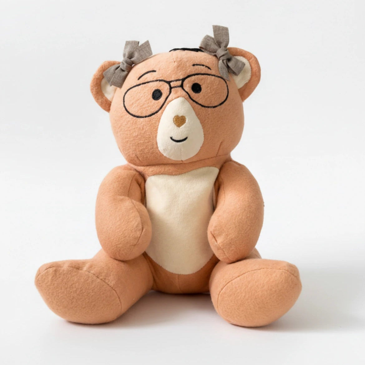 PlushPenny bear with glasses and a bow tie on a white background