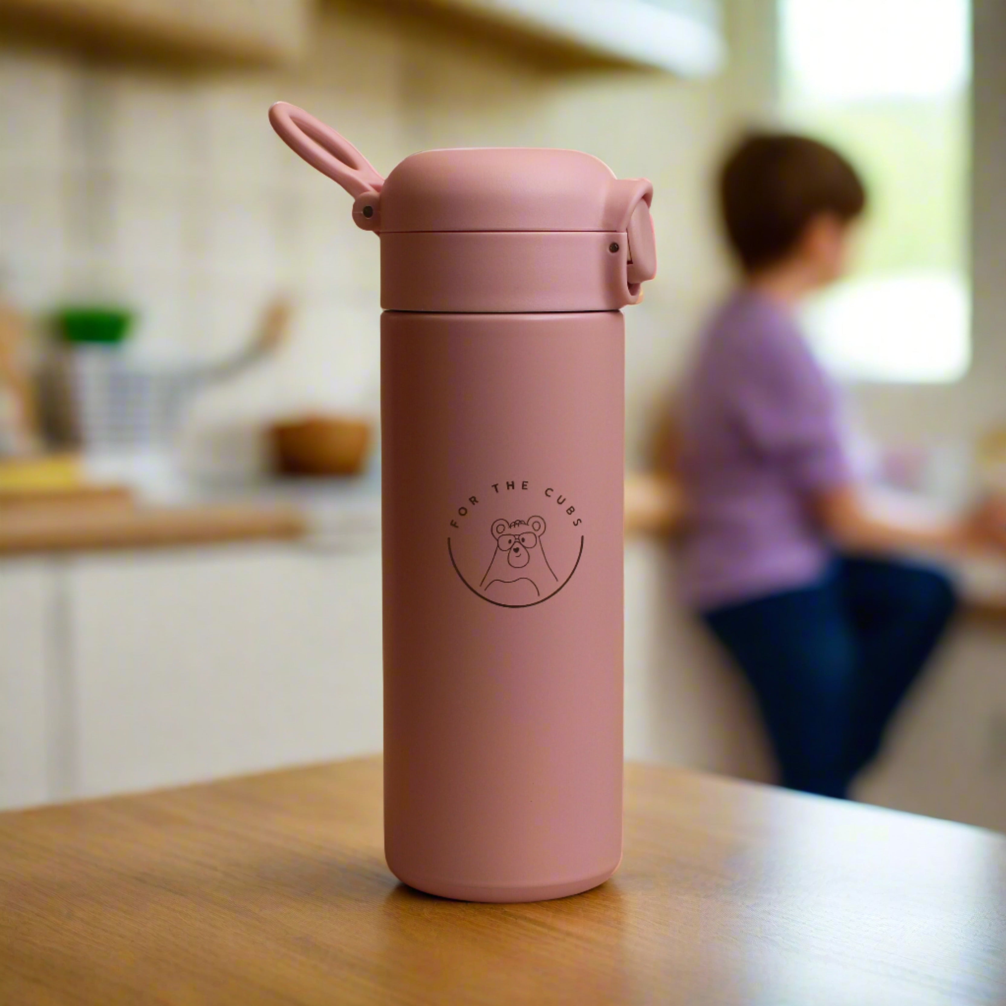 Pink water bottle front view and cap closed with loop showing