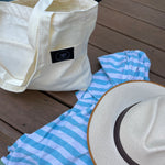 Everywhere tote bag by the pool set next to towel and straw hat