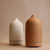 Front view of Terracotta keep calm diffuser in foreground and white keep calm diffuser in background