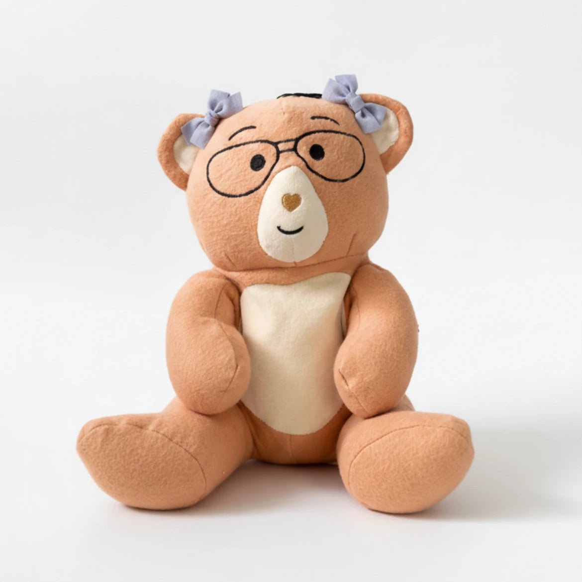 Plush Penny weighted bear with glasses and a heart on a white background