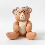 Plush Penny weighted bear with glasses and a heart on a white background