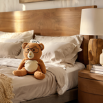 Bear sitting on bed