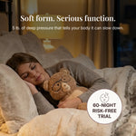 Woman sleeping with a teddy bear on a soft pillow, with text about deep pressure and a 60-night risk-free trial offer.