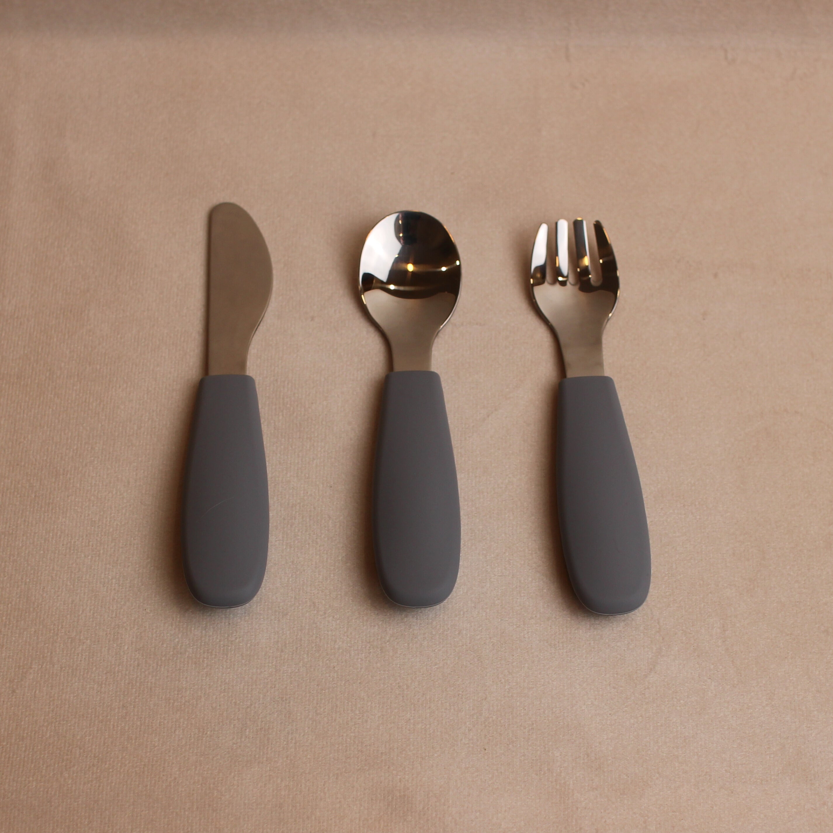 Over head view of toddler silverware in slate