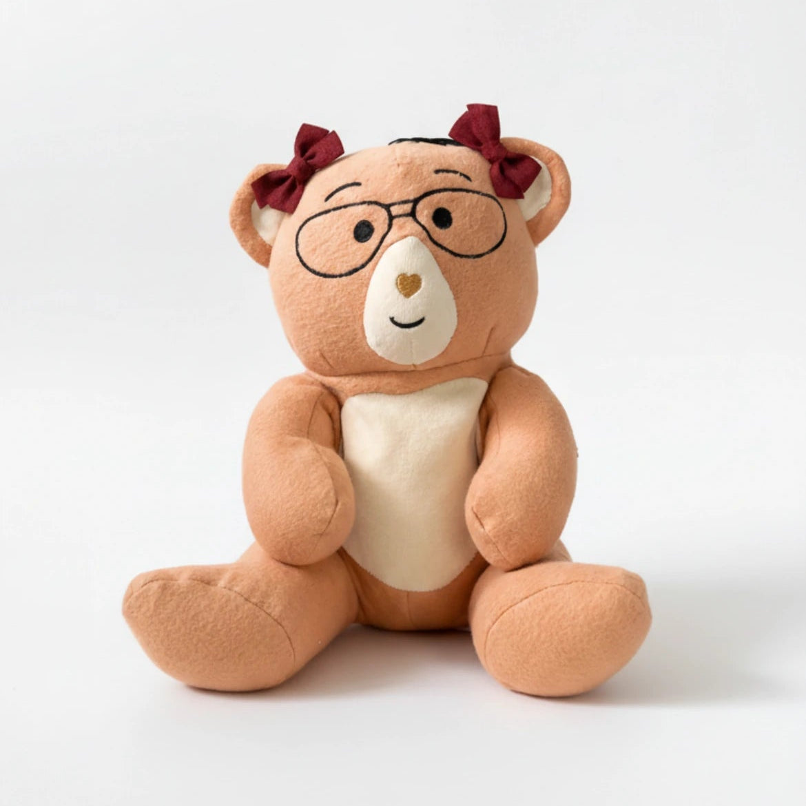 Plush Penny bear with glasses and red bows on a white background
