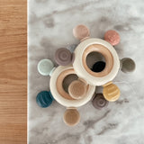 Over head view of wood and silicone teethers on marble and wood backgrounds
