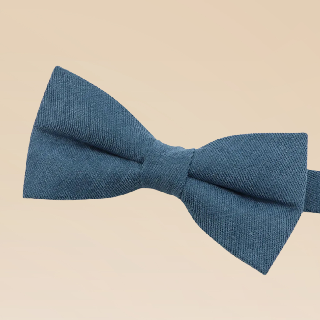 Blue bow tie on a beige background