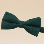 Green bow tie on a beige background