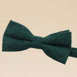 Green bow tie on a beige background