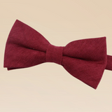 Red bow tie on a beige background