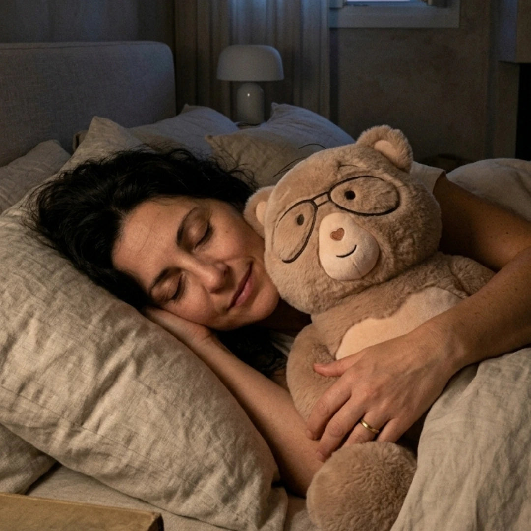 Woman sleeping in bed with weighted stuffed animal, percy bear 